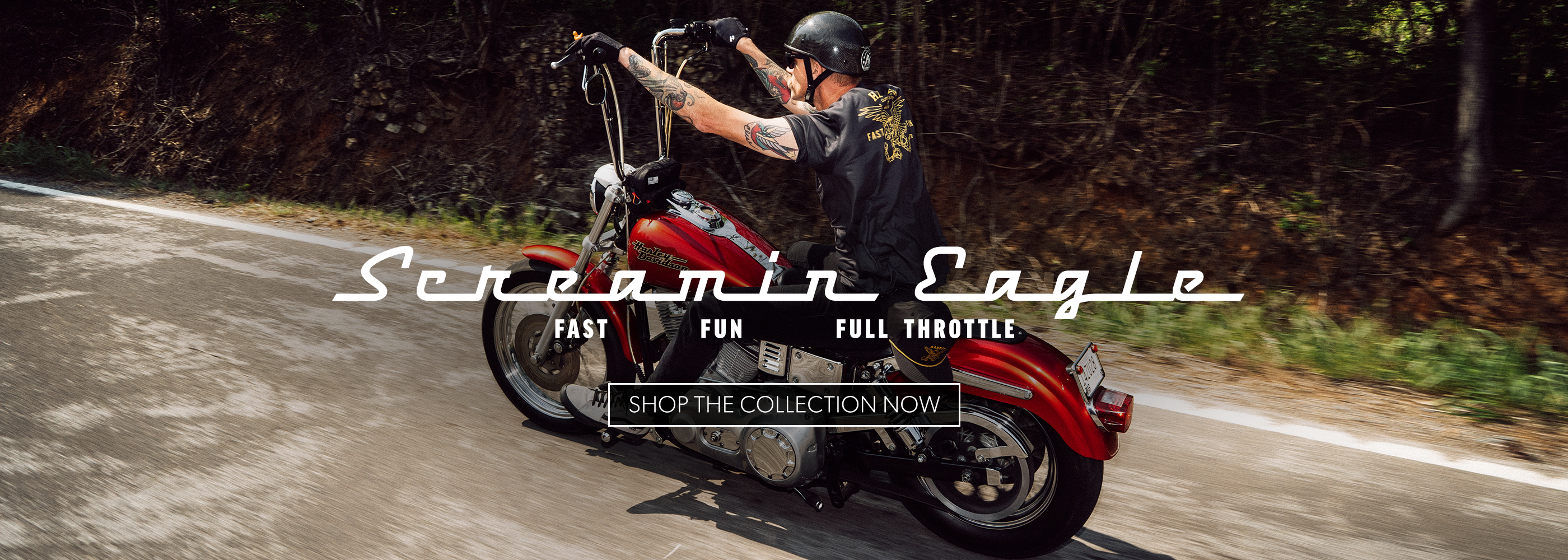 Person riding a red motorcycle on a road with 'Scramin Eagle' branding.