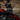 A person wearing a black leather motorcycle jacket with gold 'Screamin Eagle' graphics rides a red motorcycle on a dirt road. The image has a dark overlay with the text 'Screamin Eagle', 'FAST FUN FULL THROTTLE', and 'SHOP THE COLLECTION NOW'.