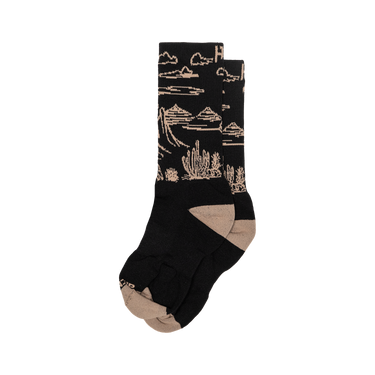 Black socks with beige desert landscape design on a white background